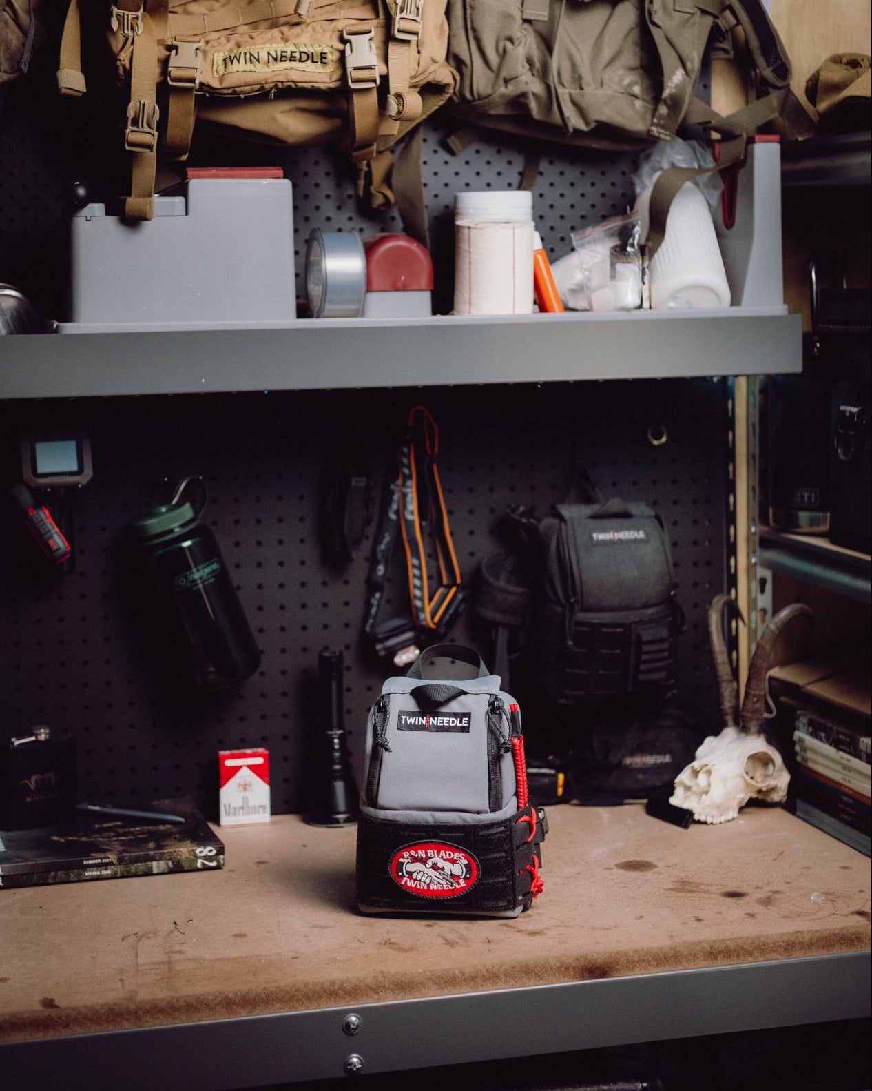Workshop or storage area with tools, equipment, and supplies on shelves.
